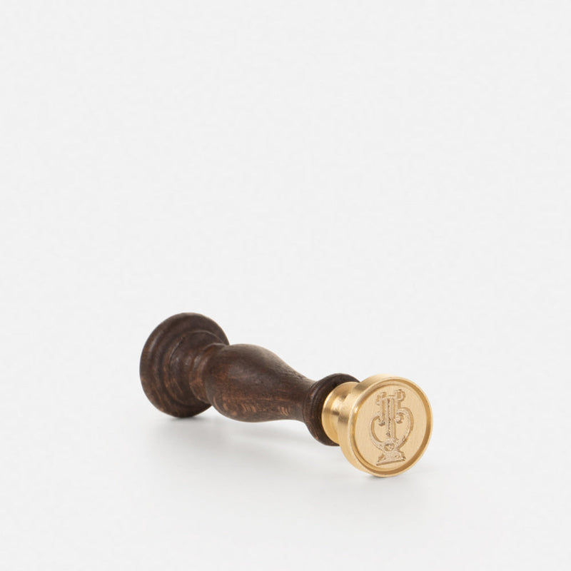 Brass seal, wooden handle and "lyre" design