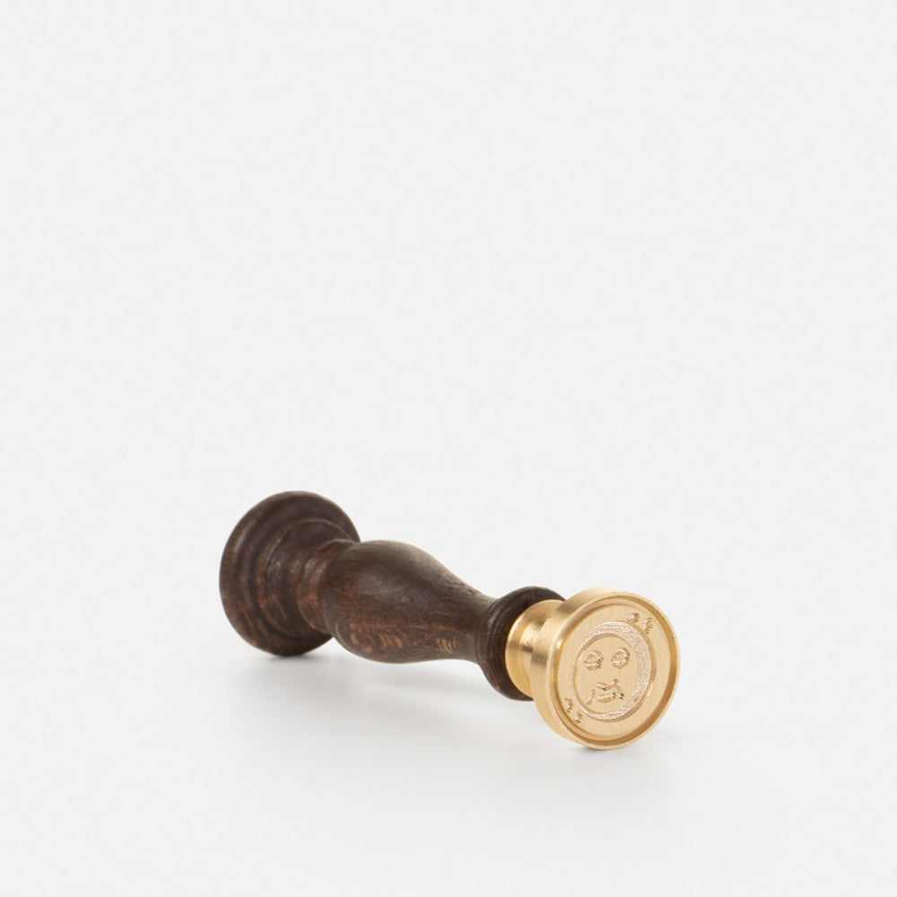 Brass seal, wooden handle and "moon" design